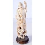 A 19TH CENTURY CHINESE CARVED IVORY FIGURE OF AN IMMORTAL modelled holding a beast. 20 cm high.