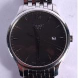 A TISSOT TRADITION MEN~S WATCH WITH AN ELEGANT STAINLESS STEEL BRACELET AND 42MM CASE, HOUSING AN AN