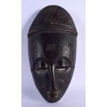 AN AFRICAN TRIBAL GURO MASK with elaborate coiffeur. 34 cm x 16 cm. Provenance: Ex Neatham Mill Coll