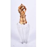 A CONTINENTAL GOLD TOPPED SCENT BOTTLE. Stamped 84, 12cm x 3cm, weight 65.9g