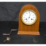 A small mantel clock with an enamelled white face. 22cm.