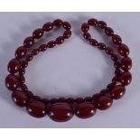CHERRY AMBER NECKLACE. Length 72cm, largest bead 22.6cm, weight 72g
