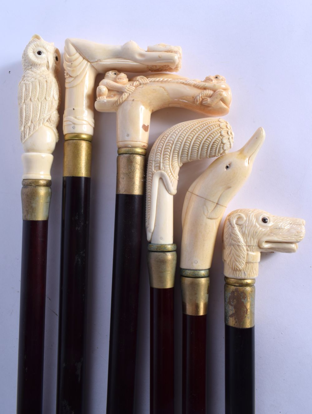 A SET OF SIX CONTINENTAL CARVED NOVELTY BONE WALKING CANES. 90 cm long. (6)