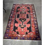 A red ground Caucasian rug 212 x 119 cm