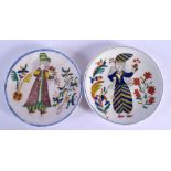 A PAIR OF TURKISH OTTOMAN KUTAHYA PLATES painted with figures. 13 cm diameter.