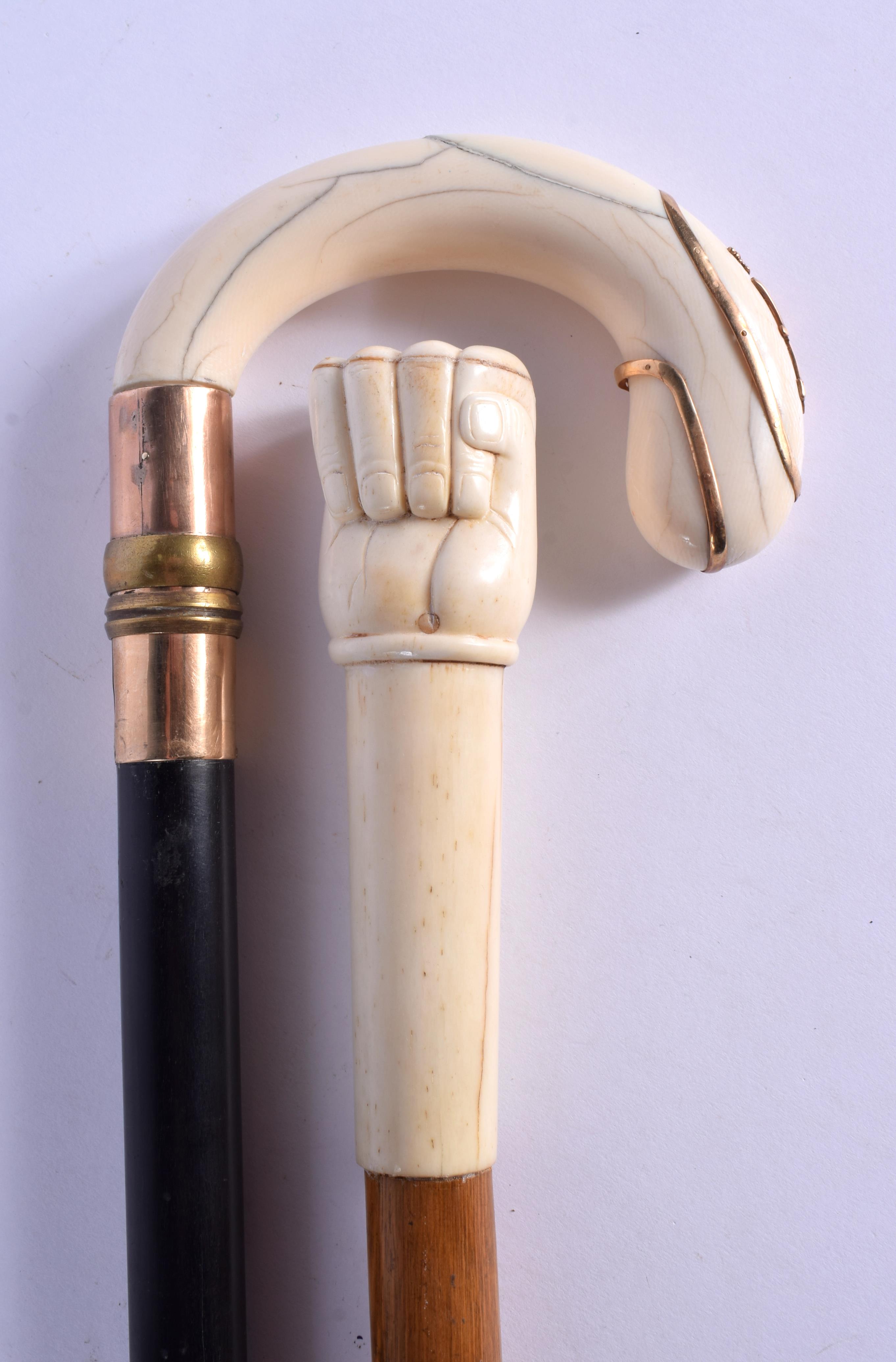 A VICTORIAN GOLD OVERLAID IVORY WALKING CANE together with a carved bone handled cane. Largest 84 cm