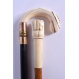 A VICTORIAN GOLD OVERLAID IVORY WALKING CANE together with a carved bone handled cane. Largest 84 cm