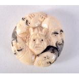 A JAPANESE BONE NETSUKE CARVED WITH FACES. 3.6cm x 1.6cm, weight 23.7g