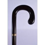 A 19TH CENTURY VICTORIAN GOLD MOUNTED CANE possibly full length horn. 380 grams. 90 cm long.