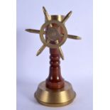 AN UNUSUAL NOVELTY 1940S BRASS COMPASS SHIPS WHEEL DESK ORNAMENT. 24 cm x 10 cm.