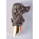 A BRASS WHISTLE IN THE SHAPE OF A DOGS HEAD. 6.6cm x 3.5cm, weight 42.9g