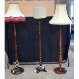 A collection of wooden lampstands with shades