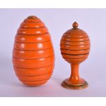 AN UNUSUAL ANTIQUE ORANGE PAINTED TREEN BOX AND COVER together with another. 7.5 cm x 3.5 cm. (2)