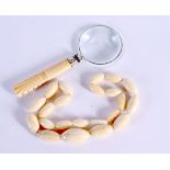 A VICTORIAN BONE HANDLED MAGNIGFYING GLASS TOGETHER WITH A BONE NECKLACE. Glass 13.8cm x 5.1cm, nec