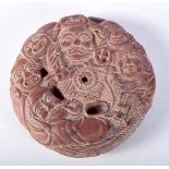 A JAPANESE WOOD ROUNDEL CARVED WITH FIGURES. 8.7cm x 2.2cm, weight 97.4g