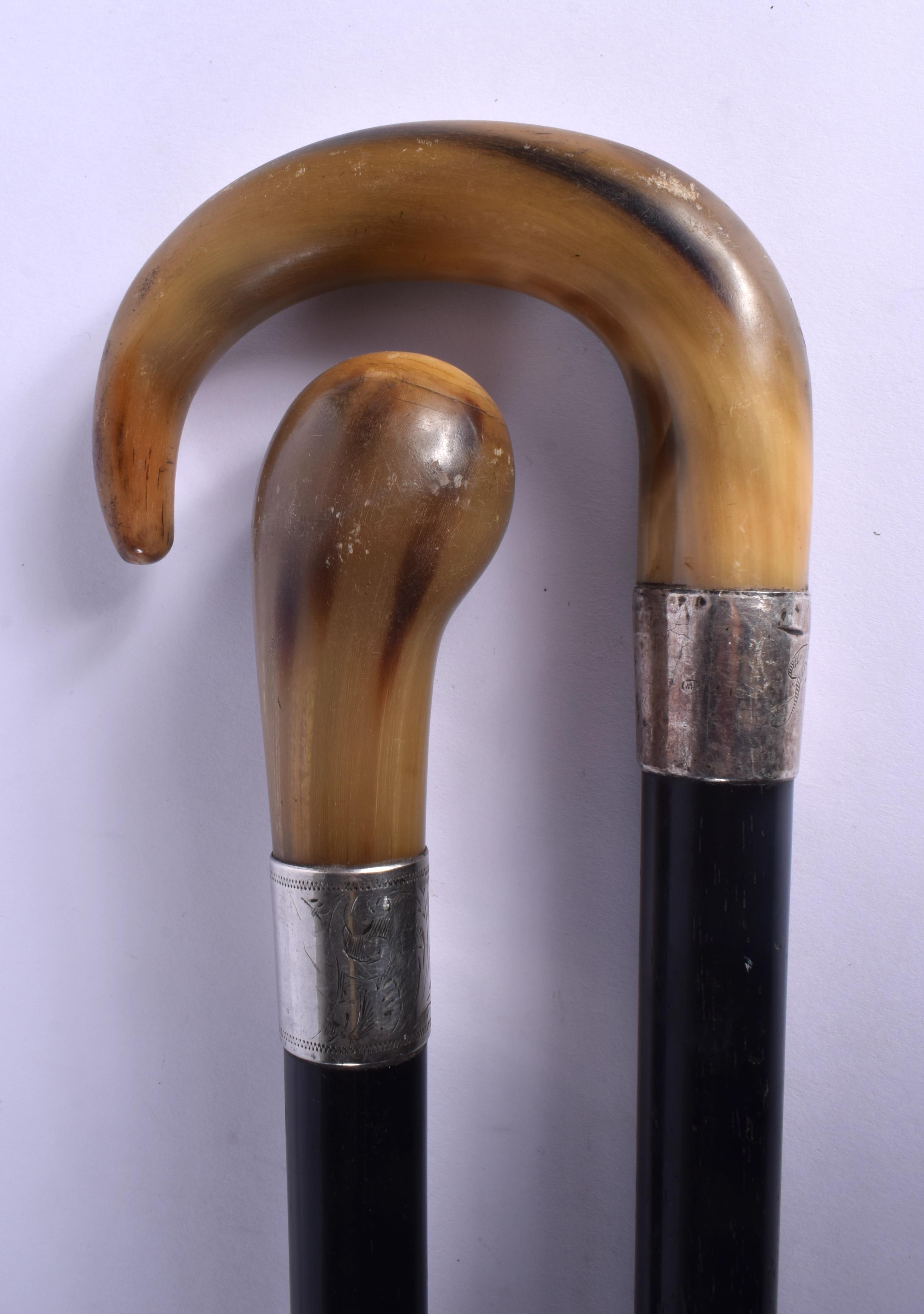 TWO 19TH CENTURY MIDDLE EASTERN CARVED RHINOCEROS HORN WALKING CANES. 90 cm long. (2)