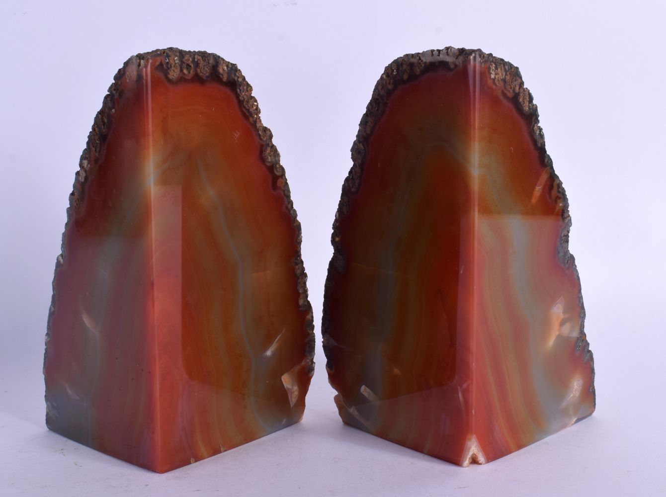 A PAIR OF SOUTH AMERICAN BRAZILIAN AGATE BOOK ENDS of naturalistic form. Each 17 cm x 7 cm.