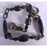 A CARVED BAKELITE TYPE BRACELET. 38cm long, weight 18g