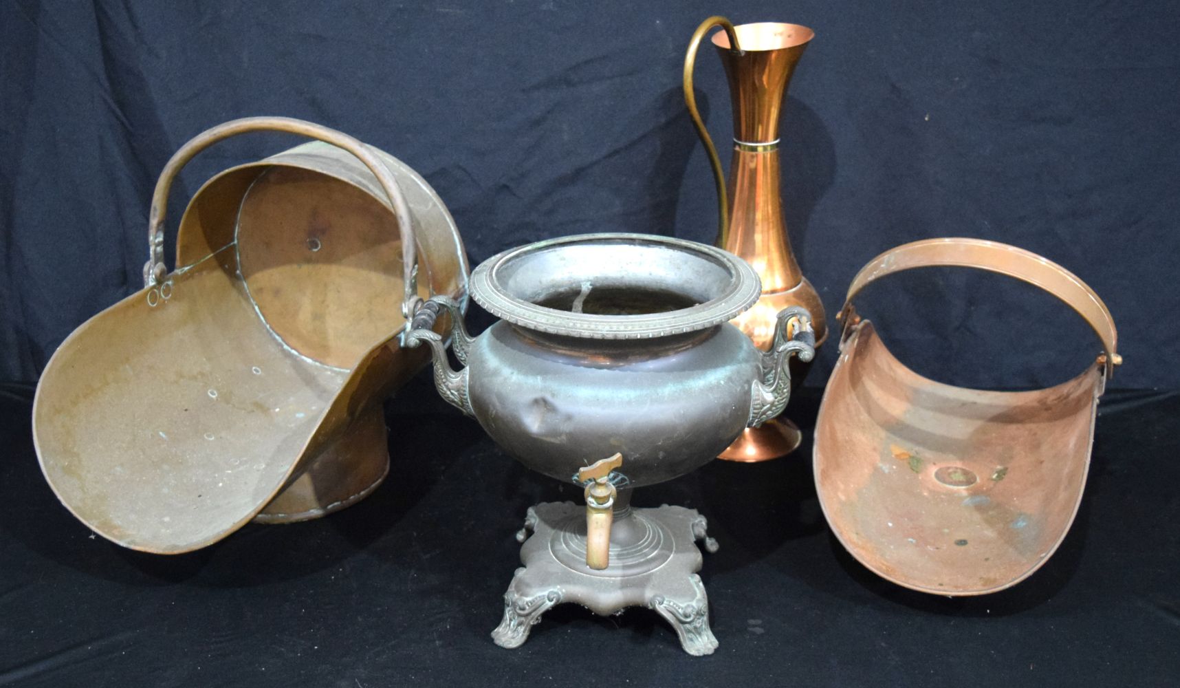 A copper coal scuttle together with a log holder, jug and a copper samovar. Largest 48cm (4).