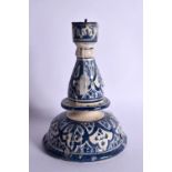 AN ISLAMIC MIDDLE EASTERN FAIENCE POTTERY CANDLESTICK. 16 cm x 8 cm.