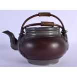 A RARE LATE 19TH CENTURY CHINESE PEWTER AND YIXING POTTERY TEAPOT AND COVER inset with a coin. 21 cm