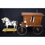 A large antique wooden model of a caravan with assorted domestic items together with an antique wood