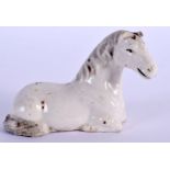 A 19TH CENTURY CHINESE BLANC DE CHINE PORCELAIN FIGURE OF A HORSE modelled recumbent. 7 cm x 5.5 cm.