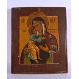 AN ANTIQUE PAINTED RUSSIAN WOOD ICON. 36 cm x 30 cm.