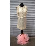 A vintage "Lovely" sequinned dress together with a pink feather fan .