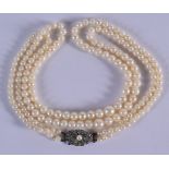 AN ART DECO SILVER MOUNTED PEARL NECKLACE. Each stand 40 cm long.