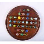 A collection of marbles and a solitaire board 20.5 cm .