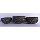 A RARE SET OF THREE LATE 19TH CENTURY CHINESE CLOISONNE ENAMEL BUDDHISTIC BOWLS decorated with folia