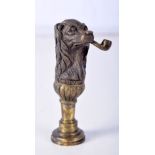 BRASS SEAL IN THE FORM OF A DOG SMOKING A PIPE. 6.3cm x 2.7cm, weight 31.1g