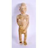 A 19TH CENTURY AFRICAN CARVED TRIBAL FERTILITY FIGURE modelled with breasts exposed. 18 cm high.