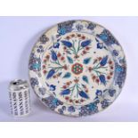 A LARGE OTTOMAN TURKISH IZNIK FAIENCE PLATE painted with flowers. 32 cm diameter.
