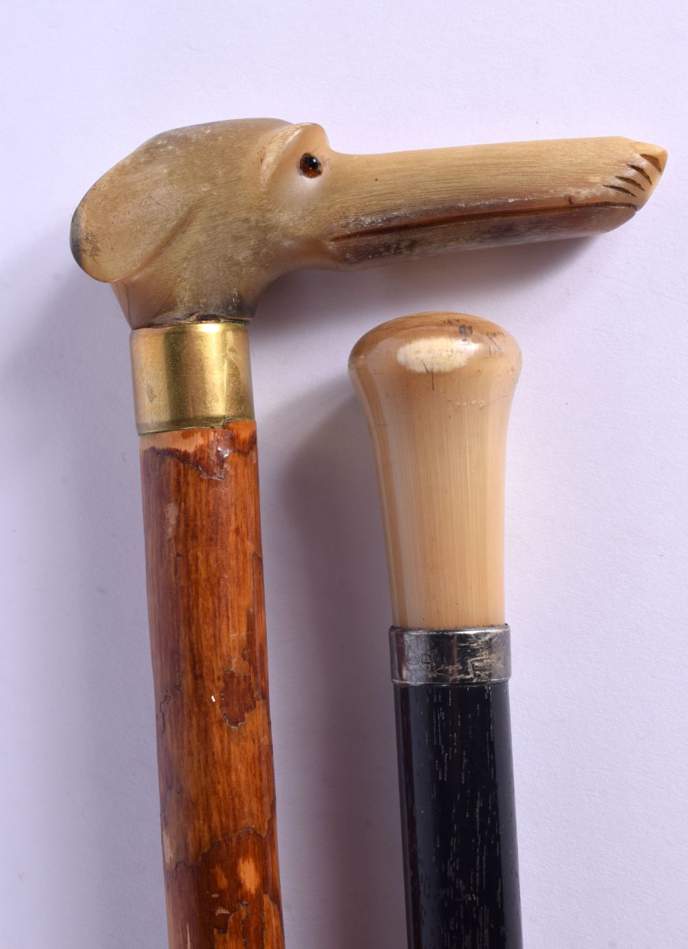 TWO 19TH CENTURY CONTINENTAL CARVED RHINOCEROS HORN WALKING CANES. 90 cm long. (2)