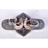 A WHITE METAL BROOCH DECORATED WITH HORSESHOES AND RIDING CROP. 3.1cm x 5.5cm, weight 10.8g