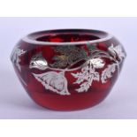 A RUBY GLASS SALT WITH SILVER FLORAL OVERLAY AND RIM. 4.4cm x 7.5cm, weight 275g
