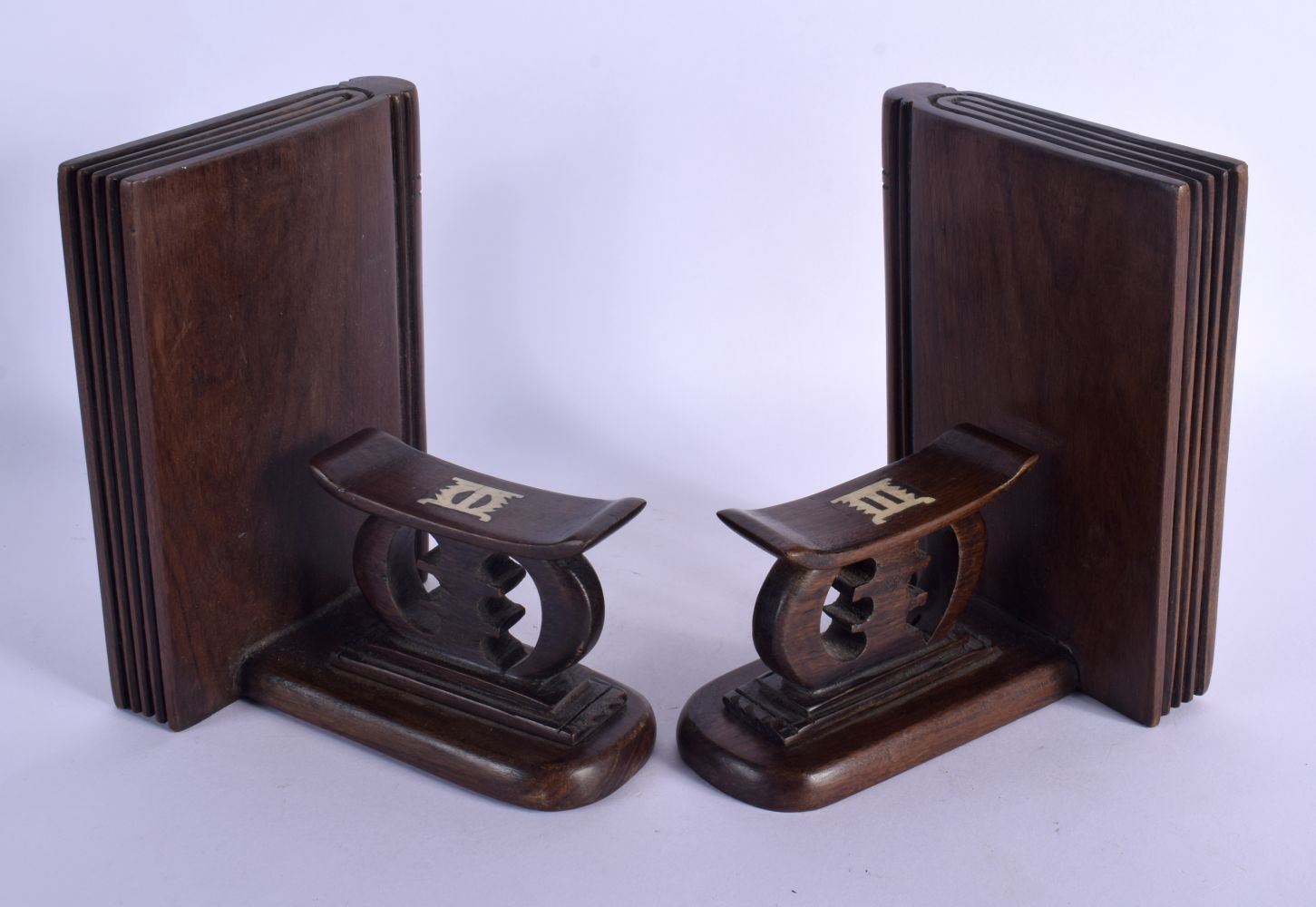 A PAIR OF EARLY 20TH CENTURY TRIBAL AFRICAN BOOK ENDS formed as head rests. Each 16 cm x 12 cm.