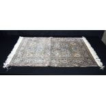 A small Chinese silk rug,. 88 x 62cm.