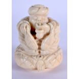 A RARE 19TH CENTURY MIDDLE EASTERN CARVED IVORY SNAKE CHARMER modelled seated upon a pillow. 7 cm x