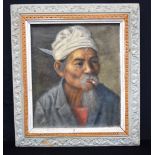A framed oil on canvas of a South East Asian male indistinctly signed 35 x 29cm