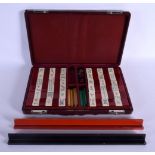 A VERY RARE EARLY 20TH CENTURY FRENCH CHINESE CHERRY AMBER CATALIN BAKELITE MAHJONG SET comprising o