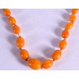 AN AMBER NECKLACE. Length 52cm, largest bead 12.8mm, weight 17.7g