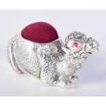 A SILVER PLATED PIN CUSHION IN THE FORM OF A SEATED CAMEL WITH GEM SET EYES. 2.8cm x 5.5cm, weight