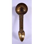 AN UNUSUAL EARLY MIDDLE EASTERN ISLAMIC GILT METAL SPOON engraved with motifs. 21 cm long.