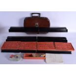 AN EARLY 20TH CENTURY CHINESE MAHJONG SET with painted black lacquer gaming counter stands. (qty)