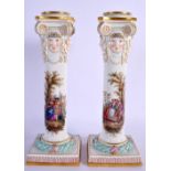A RARE PAIR OF 19TH CENTURY MEISSEN PORCELAIN CANDLESTICKS painted with figures. 24 cm high.