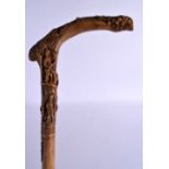 AN ANTIQUE TURKISH FOLK ART CARVED WOOD WALKING CANE. 88 cm long.