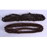 TWO ANTIQUE CONTINENTAL CARVED NUT PRAYER NECKLACES of naturalistic form. 144 cm long. (2)